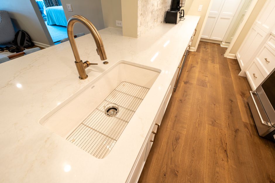 A clean, modern kitchen featuring a marble countertop and sleek fixtures, perfect for culinary inspiration.